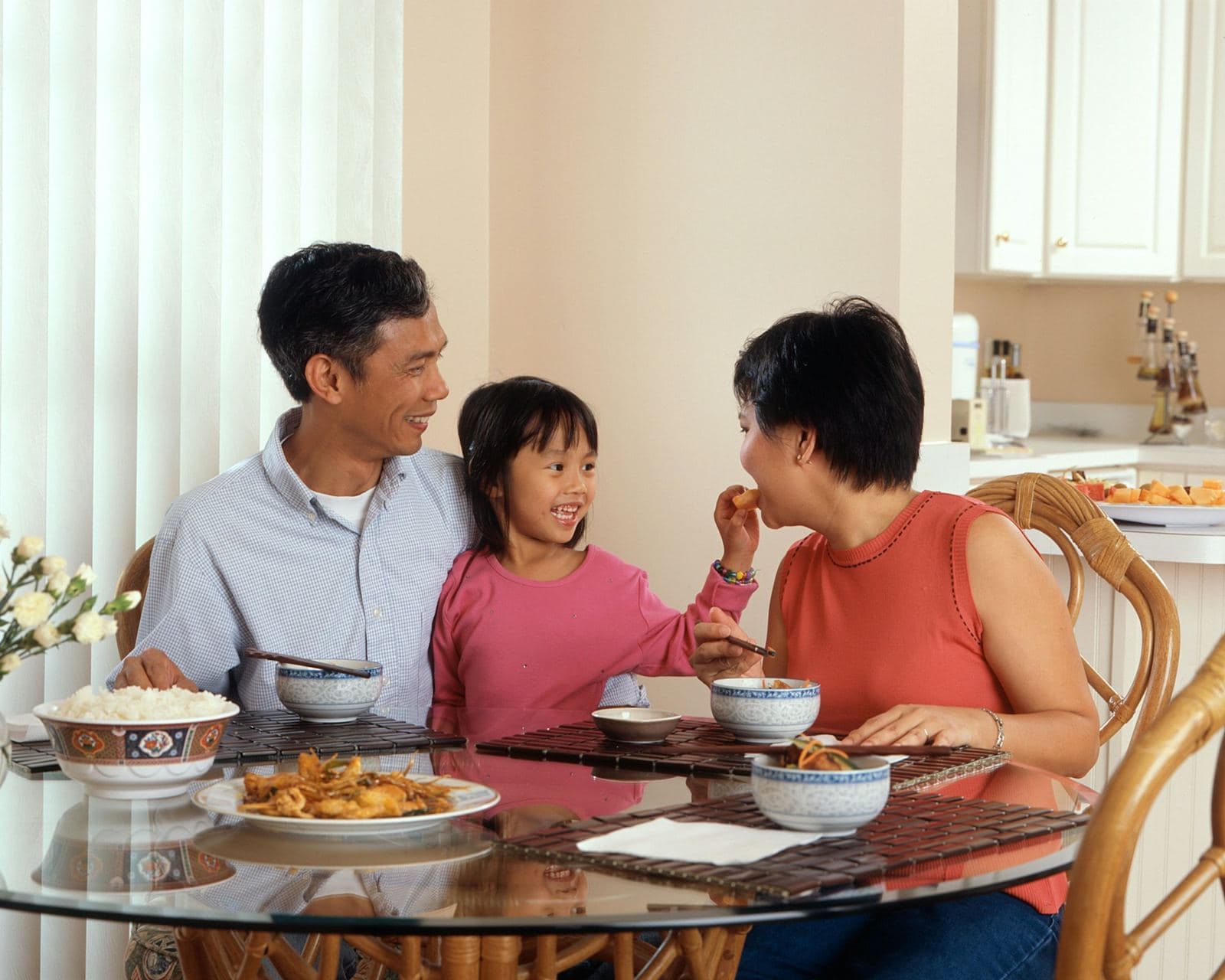 Keluarga makan bersama di meja rumah