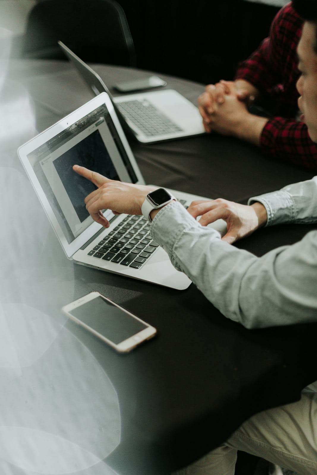 Tangan mengetik di laptop di atas meja kerja